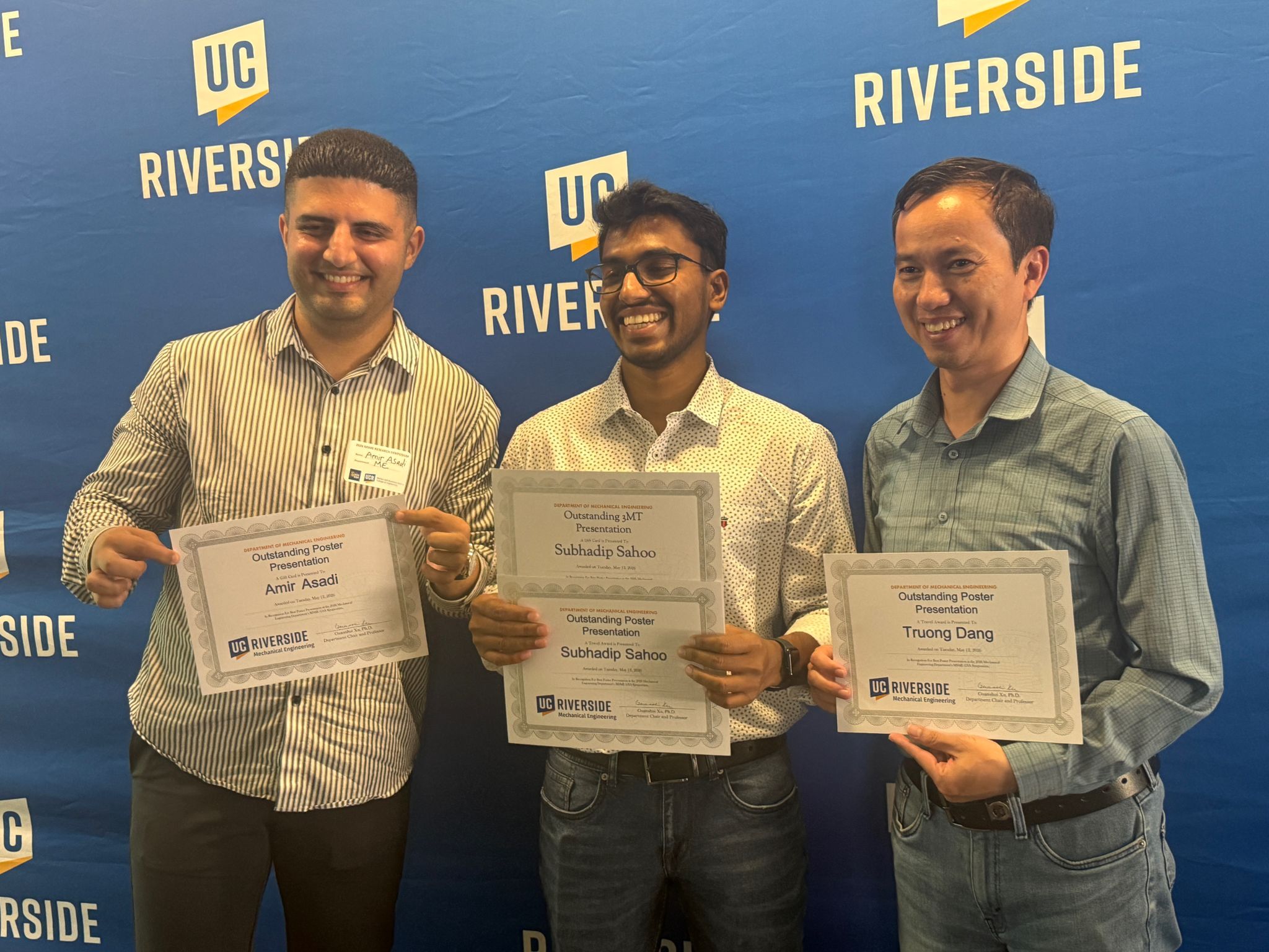 Amirreza Asadi holding the Outstanding Poster Presentation Award at UC Riverside